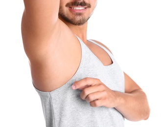 Photo of Young man showing armpit on white background, closeup. Using deodorant