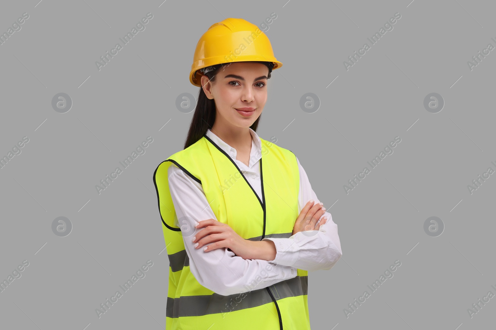 Photo of Engineer in hard hat on grey background