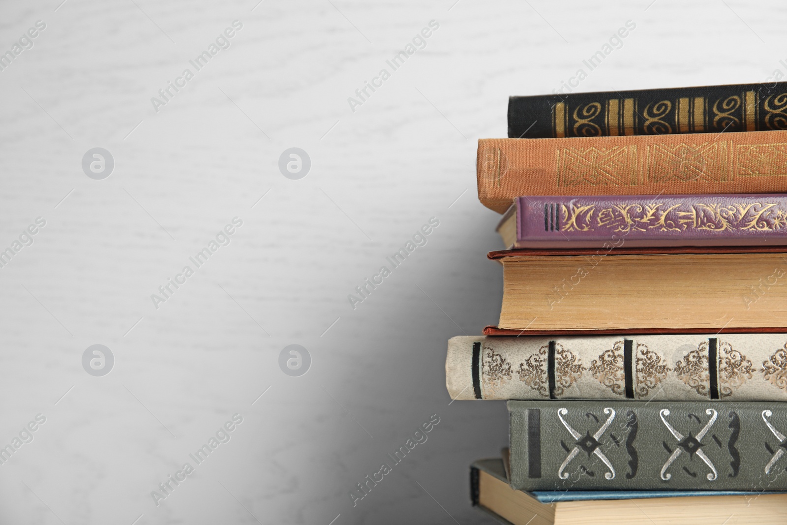 Photo of Collection of different books on white wooden background. Space for text