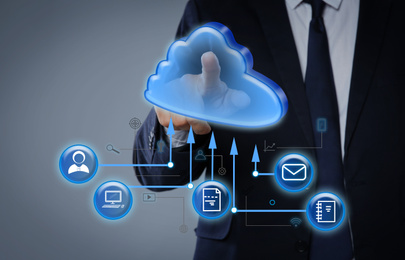 Image of Modern storage technology concept. Man touching icon of cloud on virtual screen