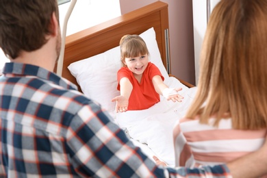 Parents visiting their little child in hospital