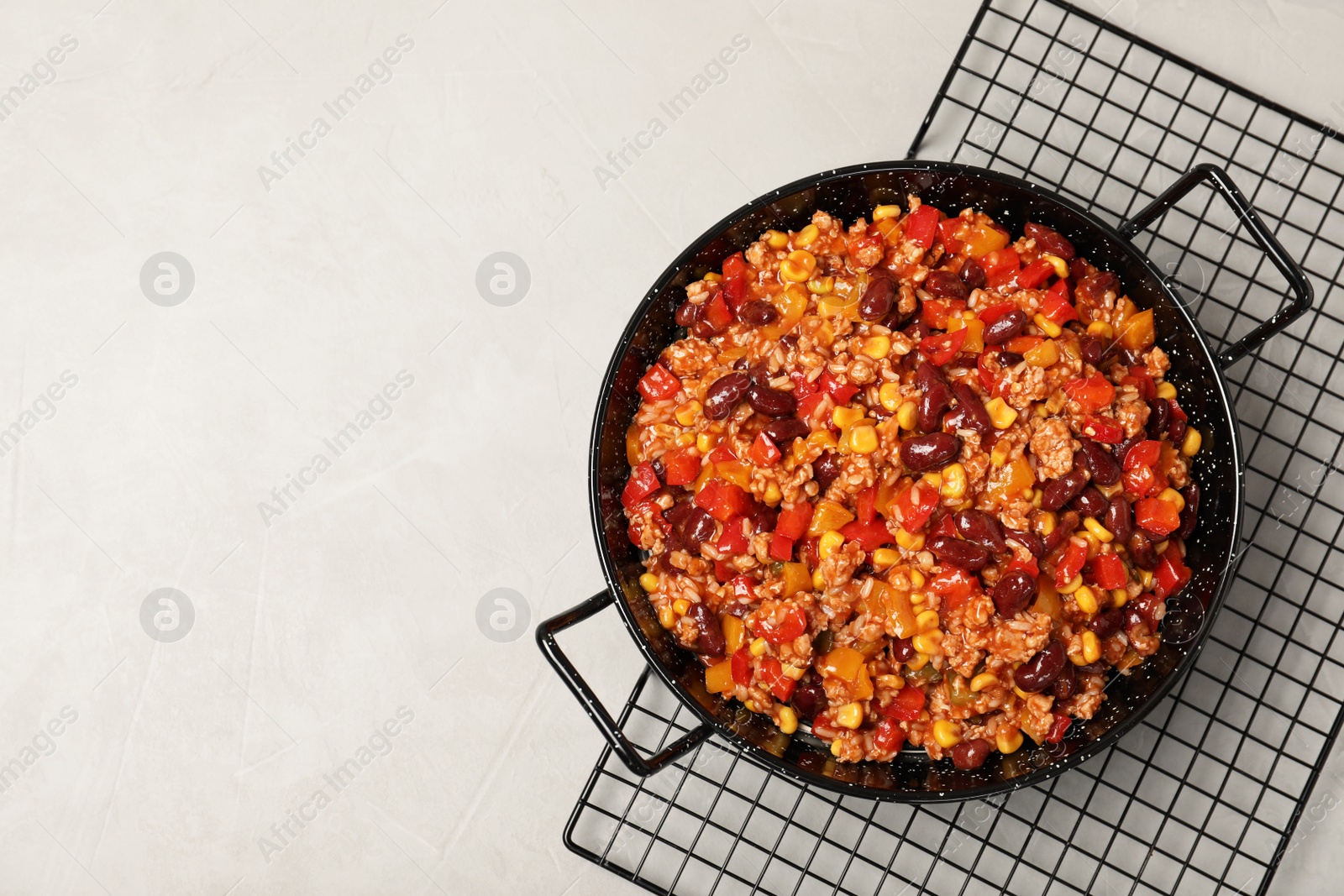 Photo of Dish with chili con carne on light background, top view. Space for text