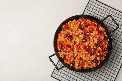 Photo of Dish with chili con carne on light background, top view. Space for text
