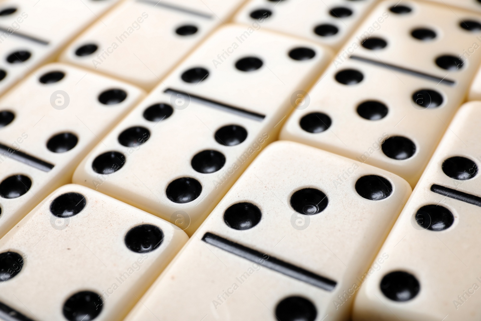 Photo of Set of classic domino tiles as background, closeup