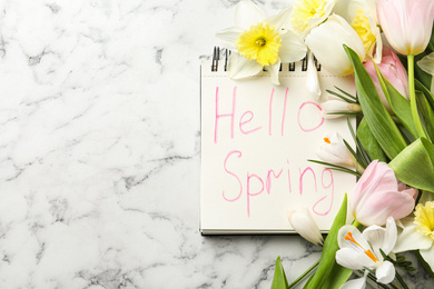 Photo of Notebook with words HELLO SPRING and fresh flowers on white marble table, flat lay. Space for text