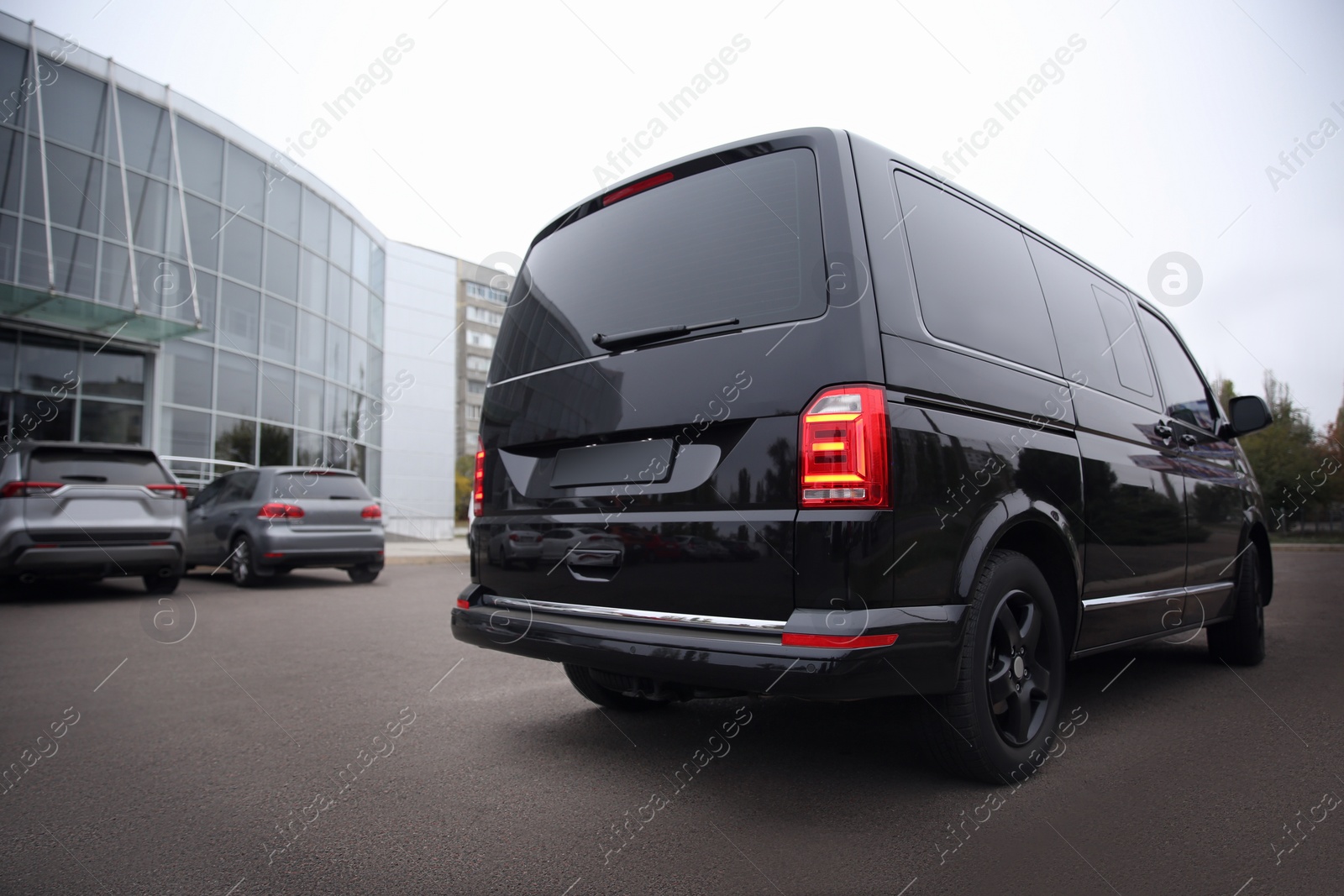 Photo of Black delivery van parked on street near building