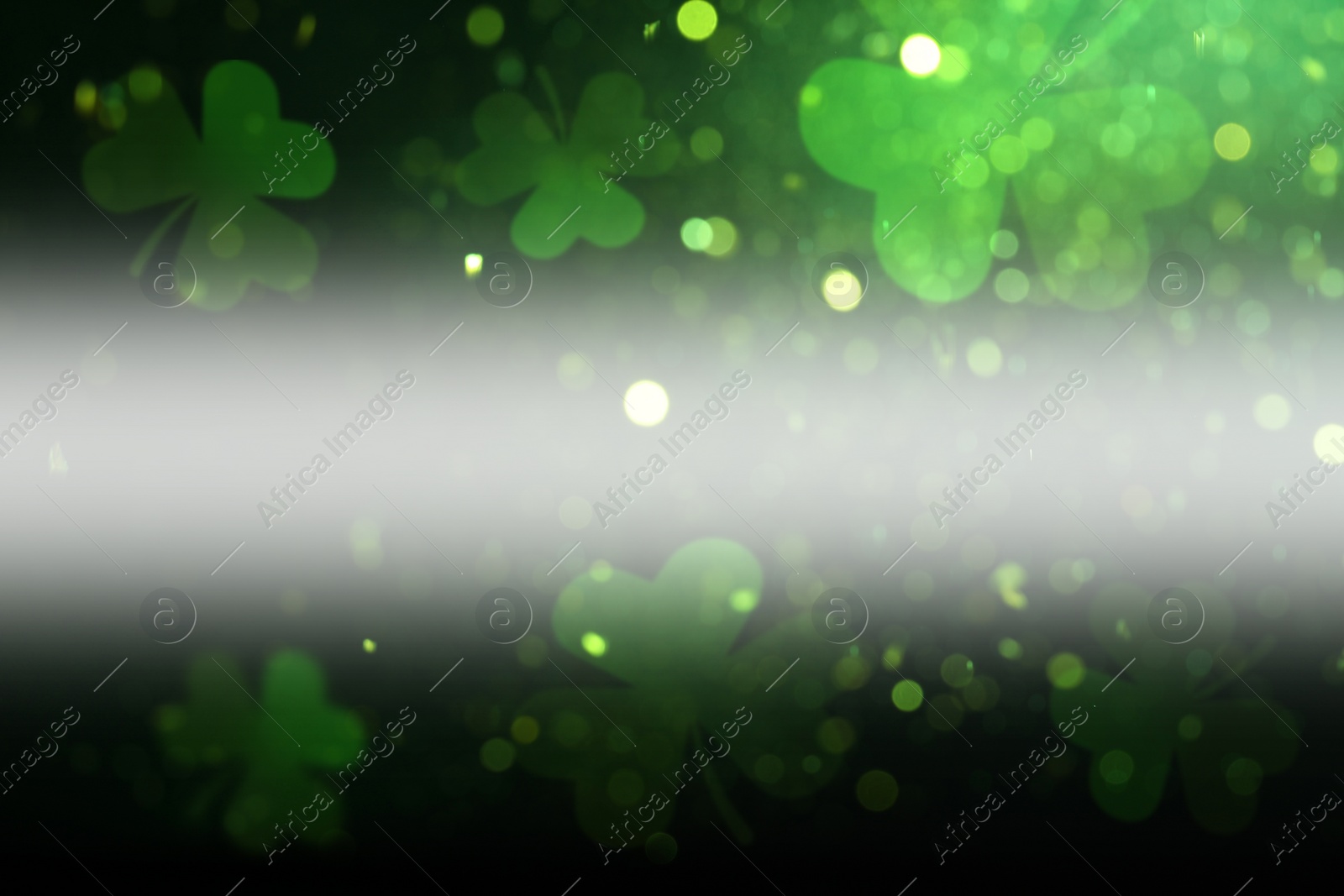 Image of St. Patrick's Day celebration. Clover leaves on dark background, bokeh effect