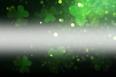 Image of St. Patrick's Day celebration. Clover leaves on dark background, bokeh effect