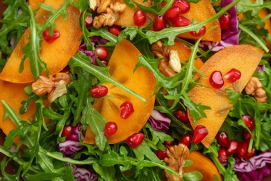 Photo of Delicious persimmon salad as background, top view
