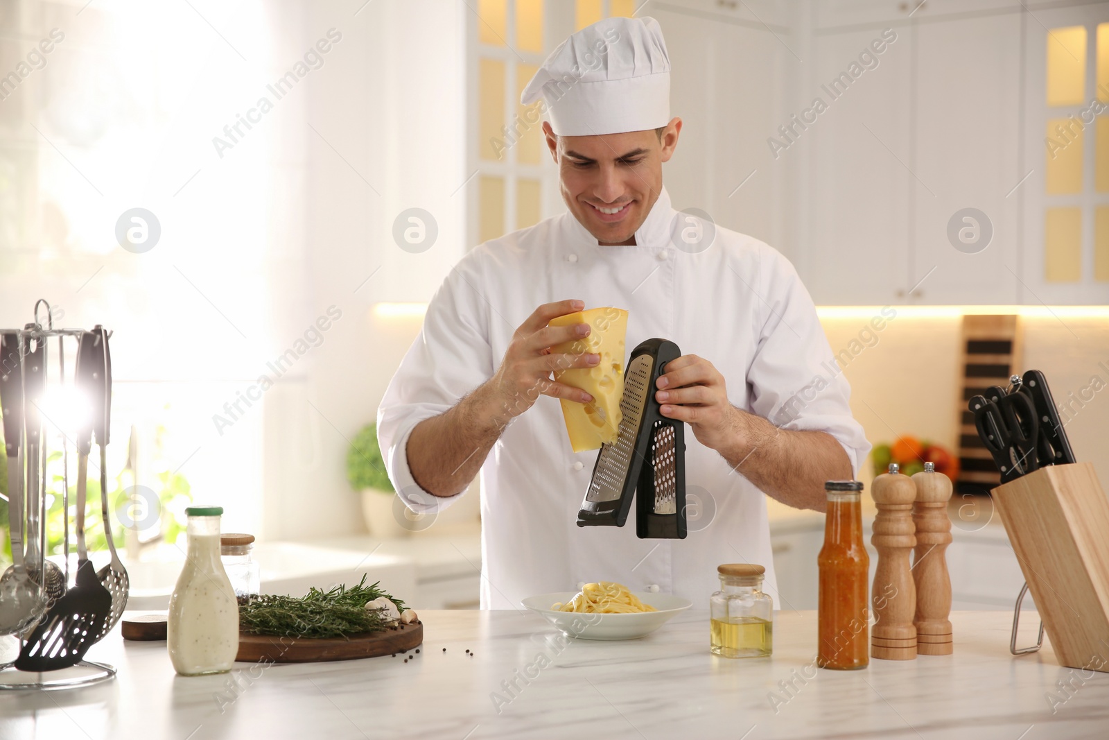 Photo of Professional chef cooking at table in kitchen