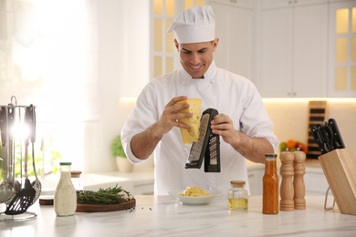 Professional chef cooking at table in kitchen