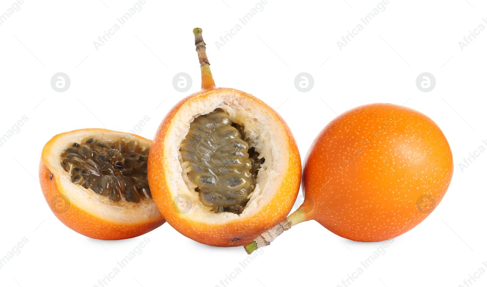 Photo of Whole and cut delicious granadillas on white background