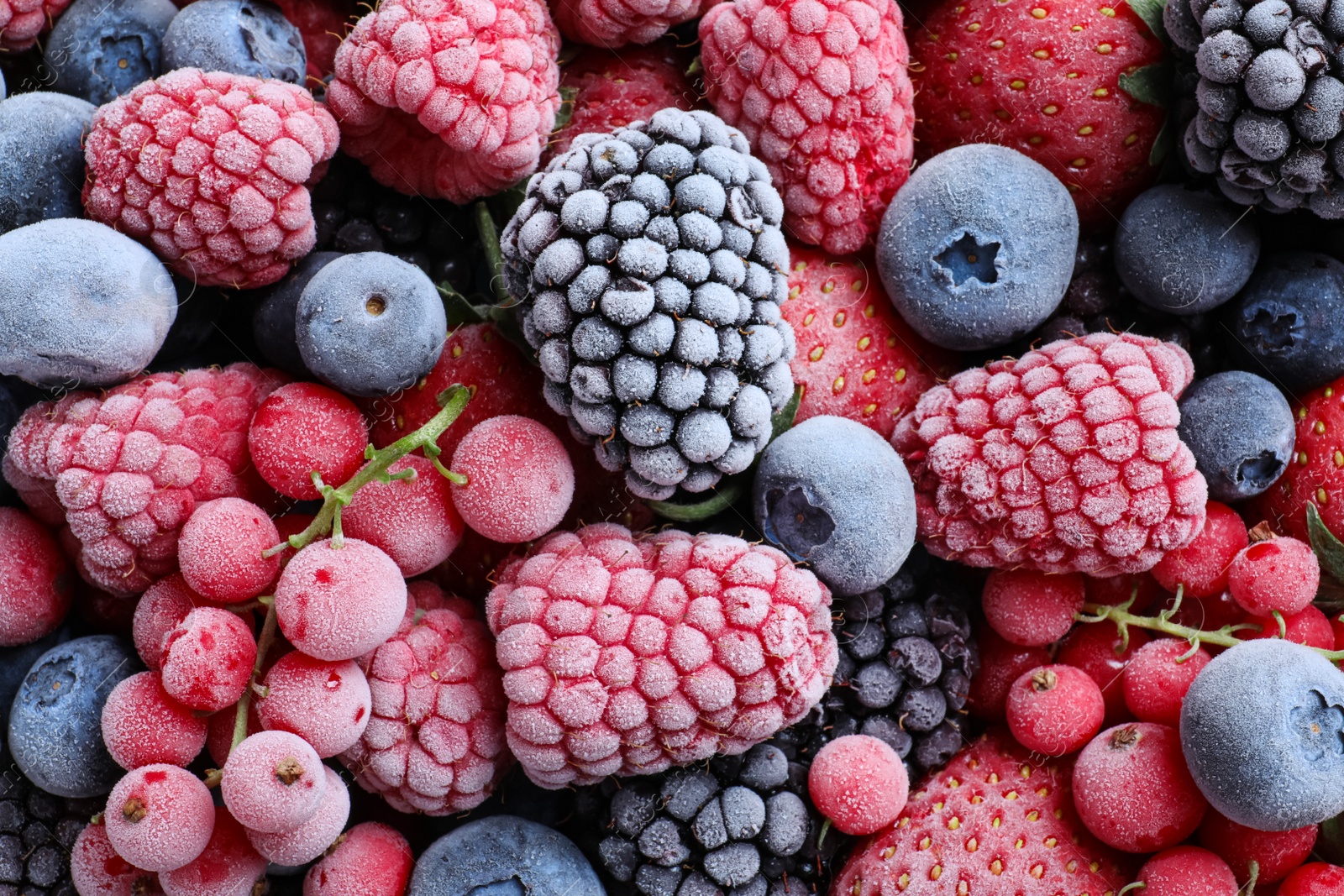 Photo of Mix of different frozen berries as background, top view