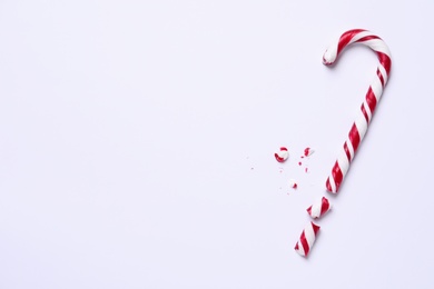 Photo of Sweet candy cane on white background, top view