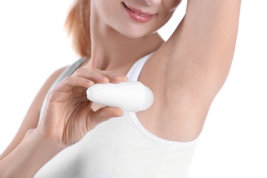 Photo of Young woman using deodorant on white background, closeup