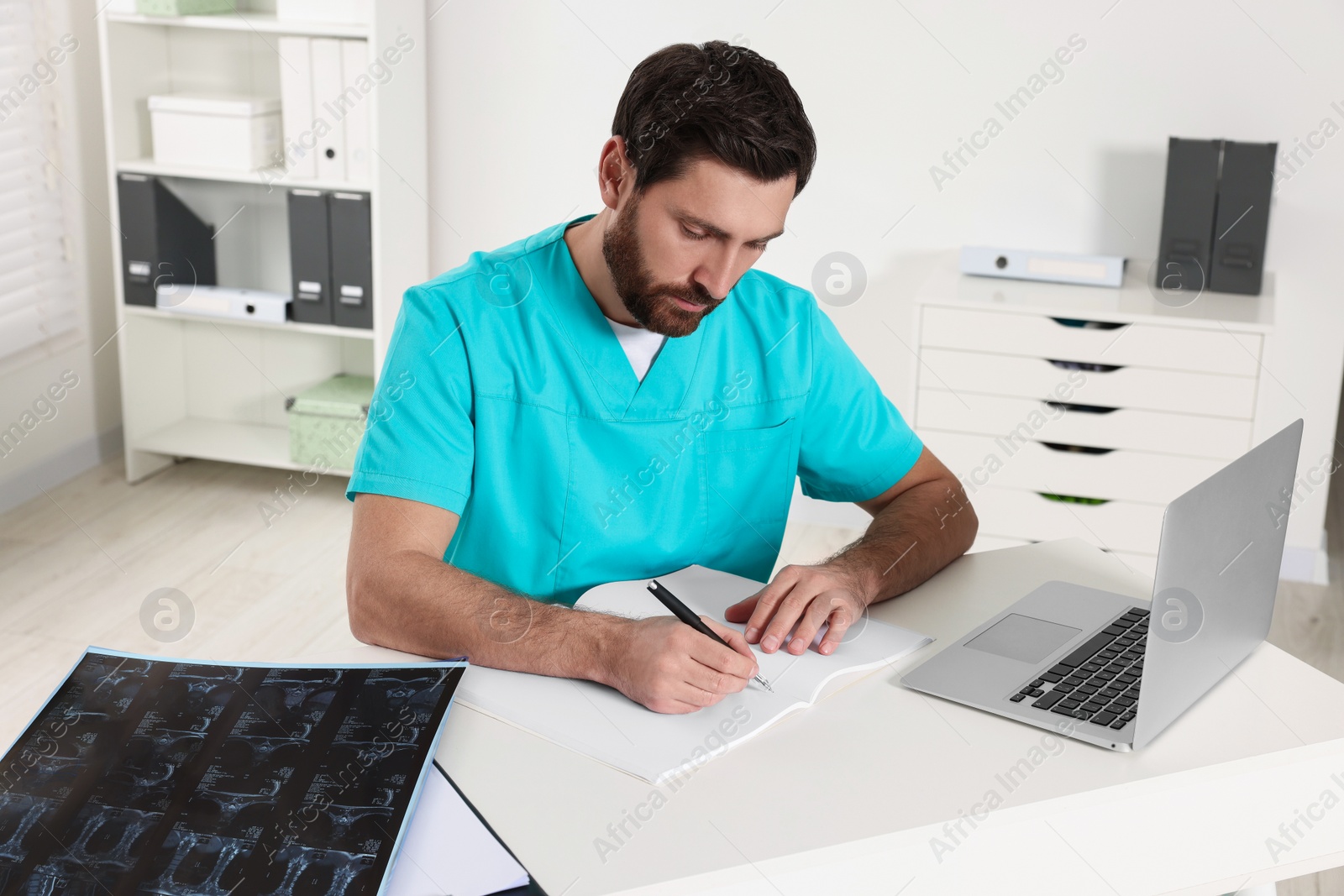 Photo of Doctor writing results from MRI scan in hospital