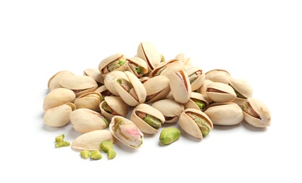 Heap of organic pistachio nuts isolated on white