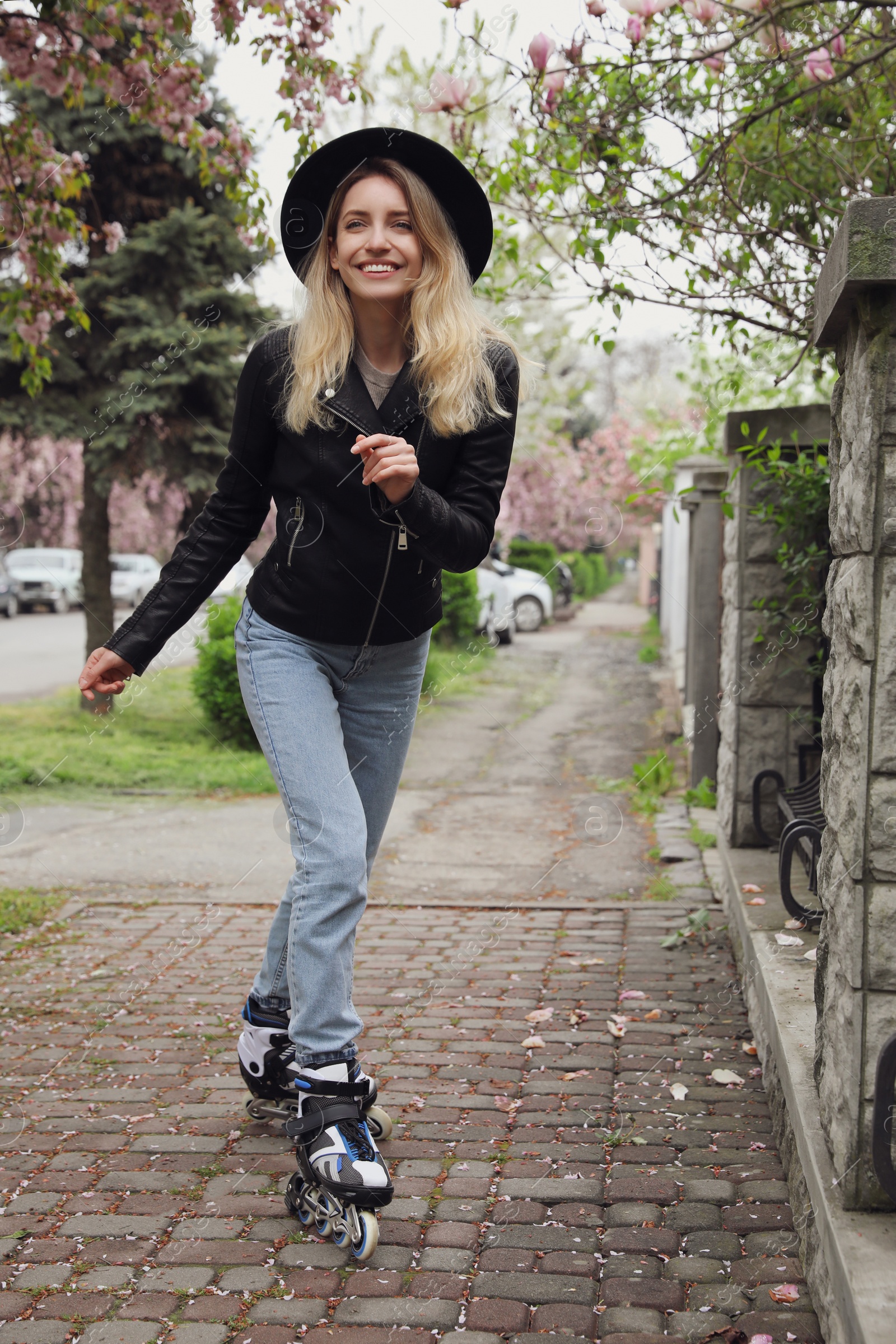 Photo of Young woman roller skating on spring day