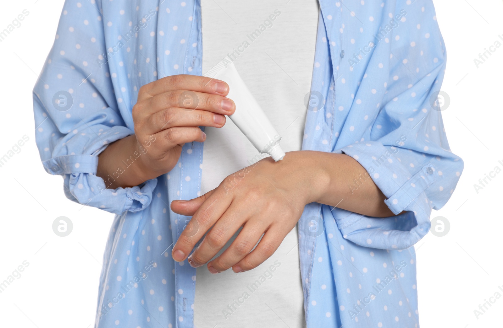 Photo of Woman applying cream on her hand against white background, closeup