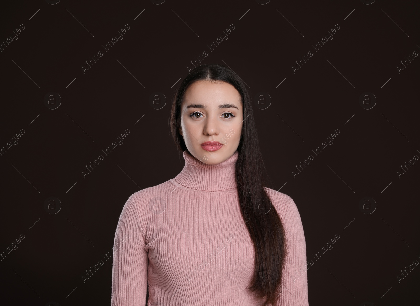 Photo of Portrait of beautiful young woman on dark background