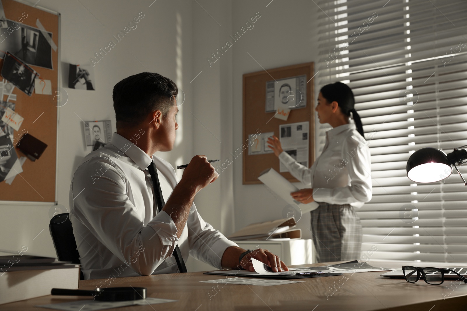 Photo of Professional detectives working on case in office