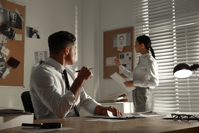 Professional detectives working on case in office