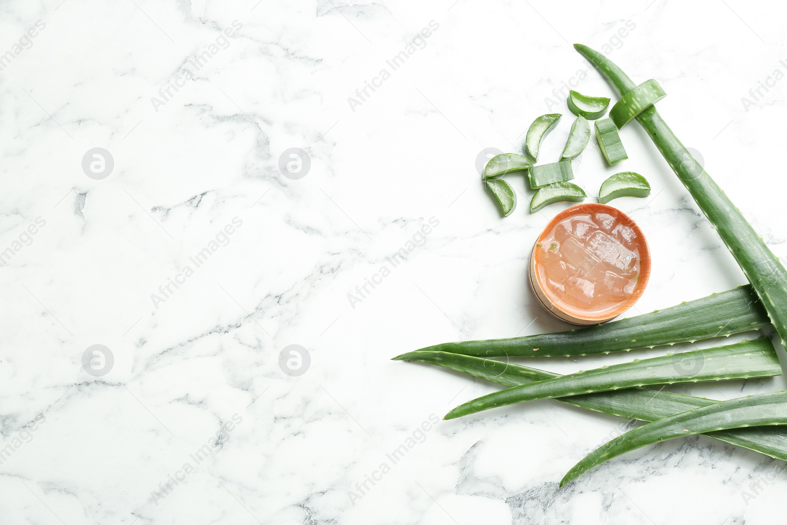 Photo of Flat lay composition with aloe vera leaves on marble background. Space for text