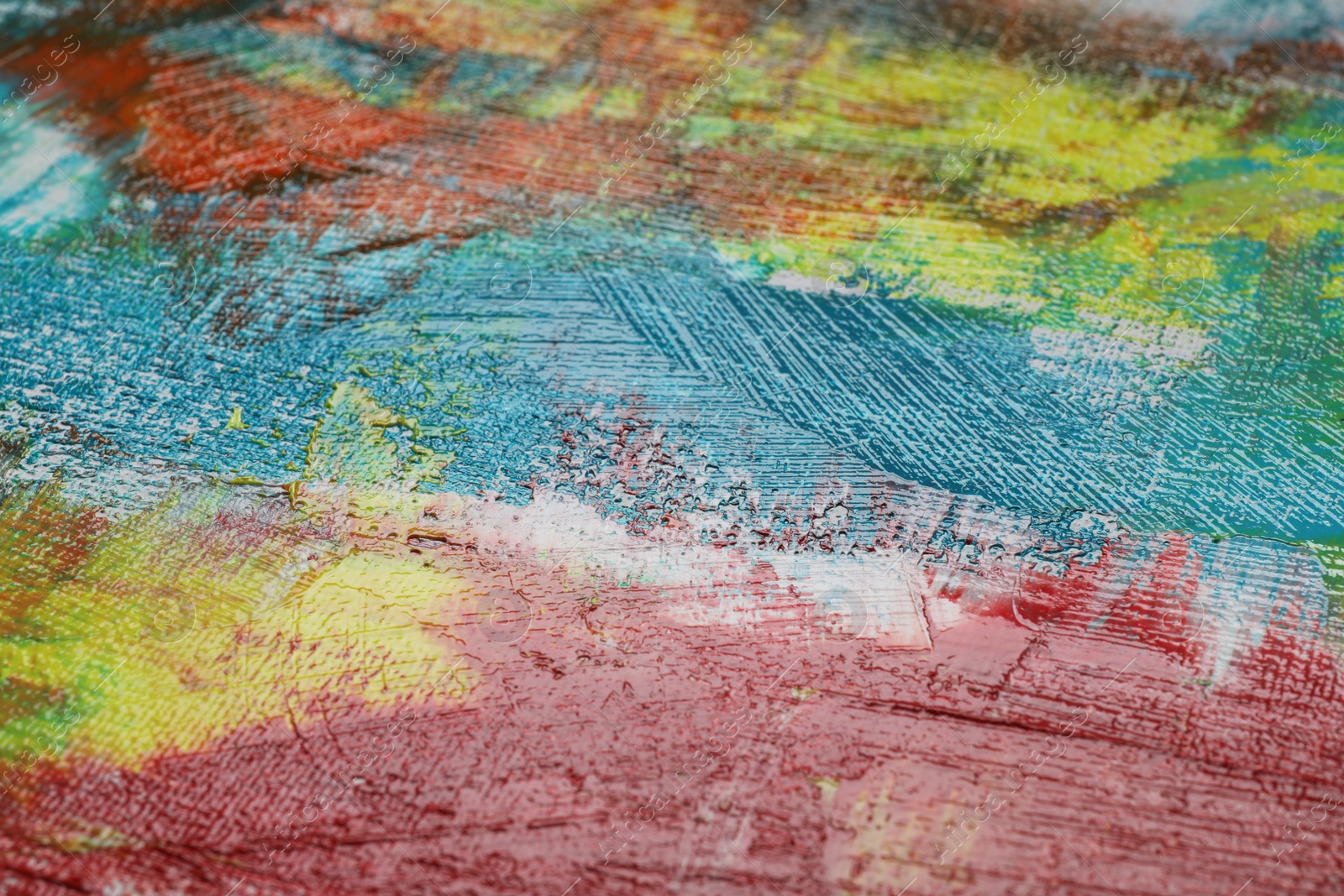 Photo of Strokes of colorful acrylic paints on canvas, closeup