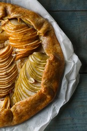 Delicious apple galette with walnuts on wooden table, top view