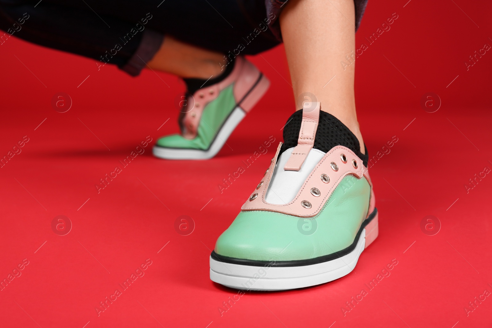 Photo of Woman in stylish shoes on color background