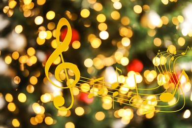 Music notes on blurred background, bokeh effect. Christmas and New Year melody