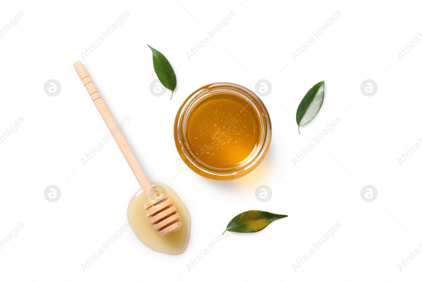 Photo of Tasty honey in glass jar, leaves and dipper on white background, flat lay