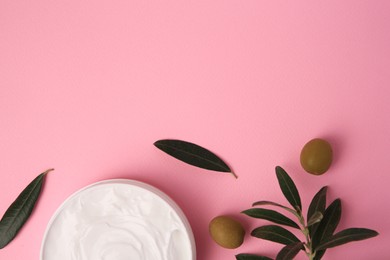 Photo of Natural cosmetic. Olive cream and ingredient on pink background, flat lay. Space for text