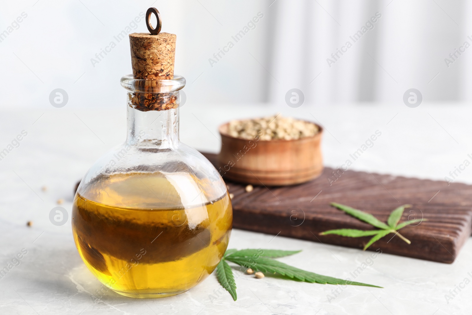 Photo of Composition with hemp oil on white table