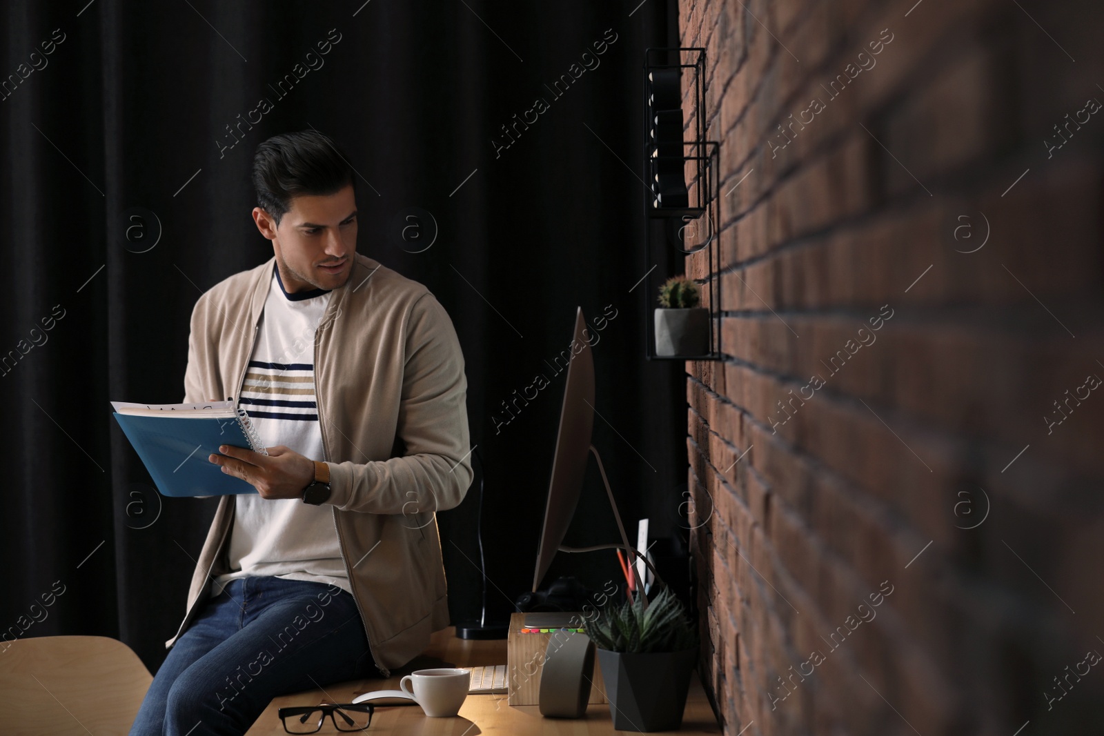 Photo of Journalist with notebook at workplace in office