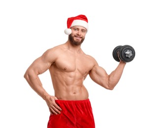 Photo of Attractive young man with muscular body in Santa hat holding dumbbell on white background