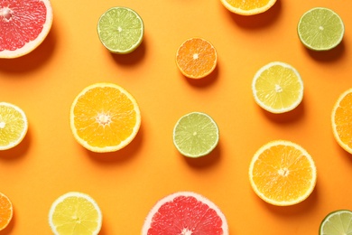 Photo of Different citrus fruits on color background, flat lay