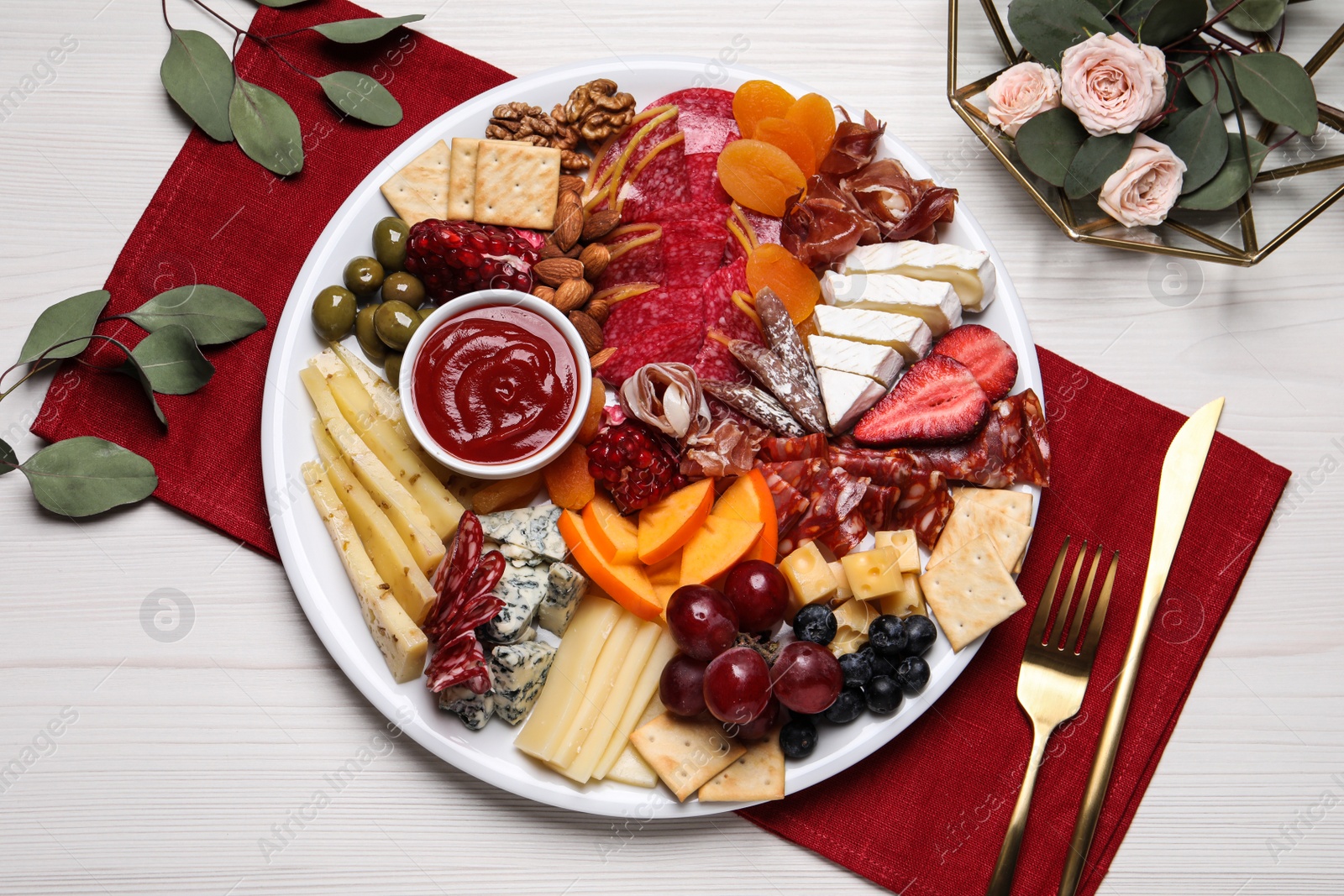 Photo of Plate of different appetizers with sauce served on white wooden table, flat lay