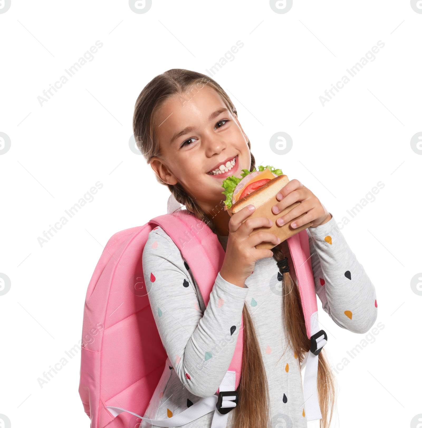 Photo of Schoolgirl with healthy food and backpack on white background