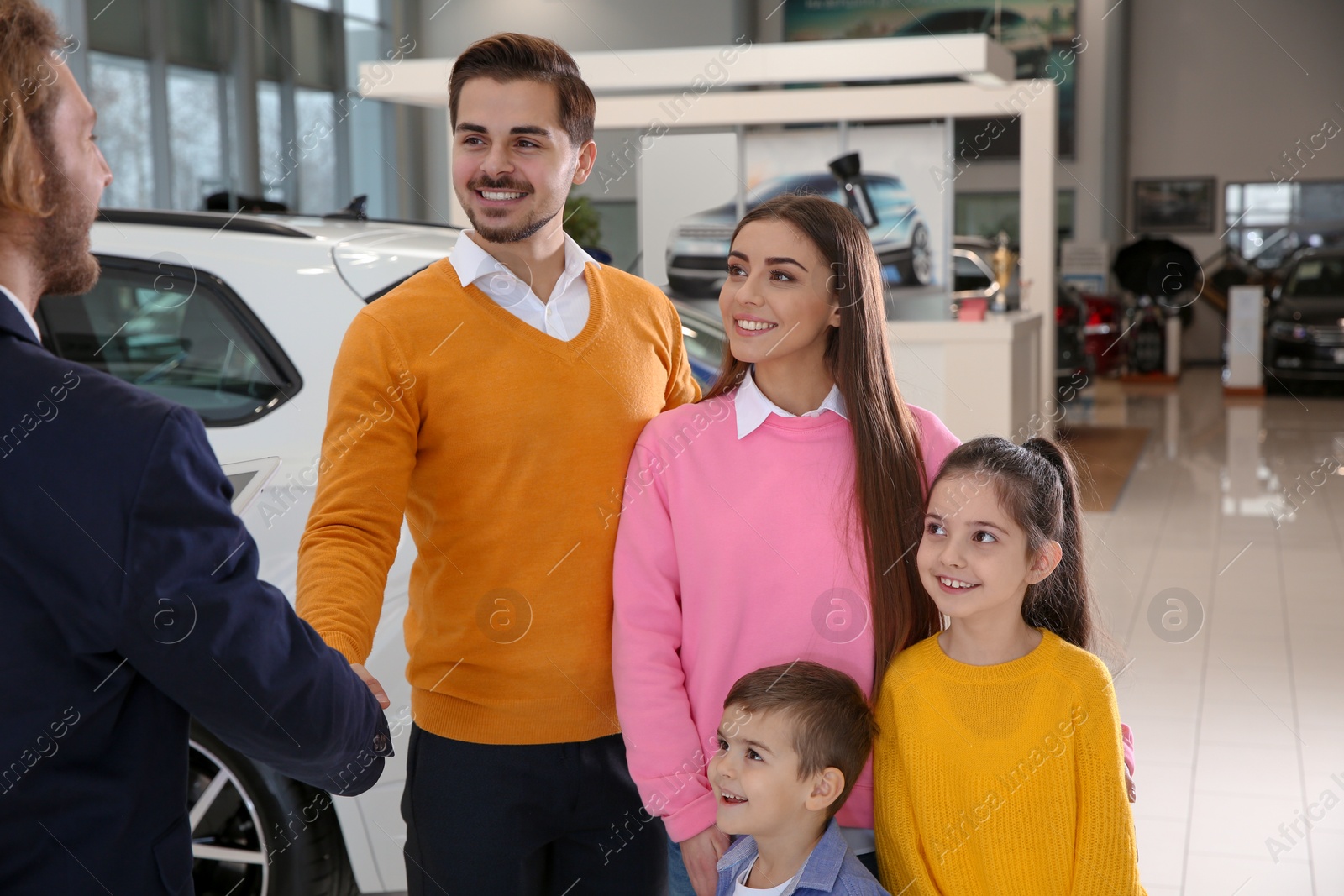 Photo of Car salesman working with family in dealership