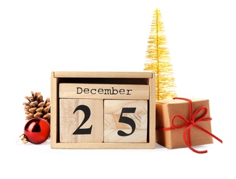 Photo of Wooden block calendar and festive decor on white background