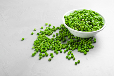 Photo of Frozen peas on light grey table. Vegetable preservation