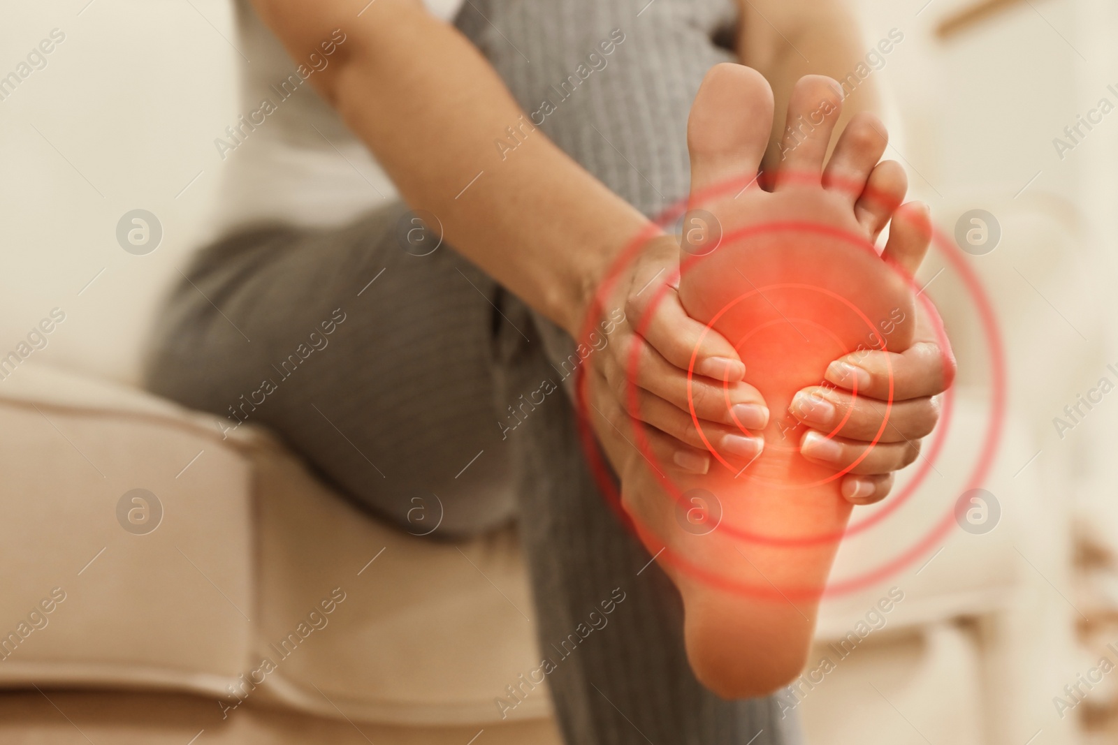 Image of Young woman suffering from foot pain indoors, closeup