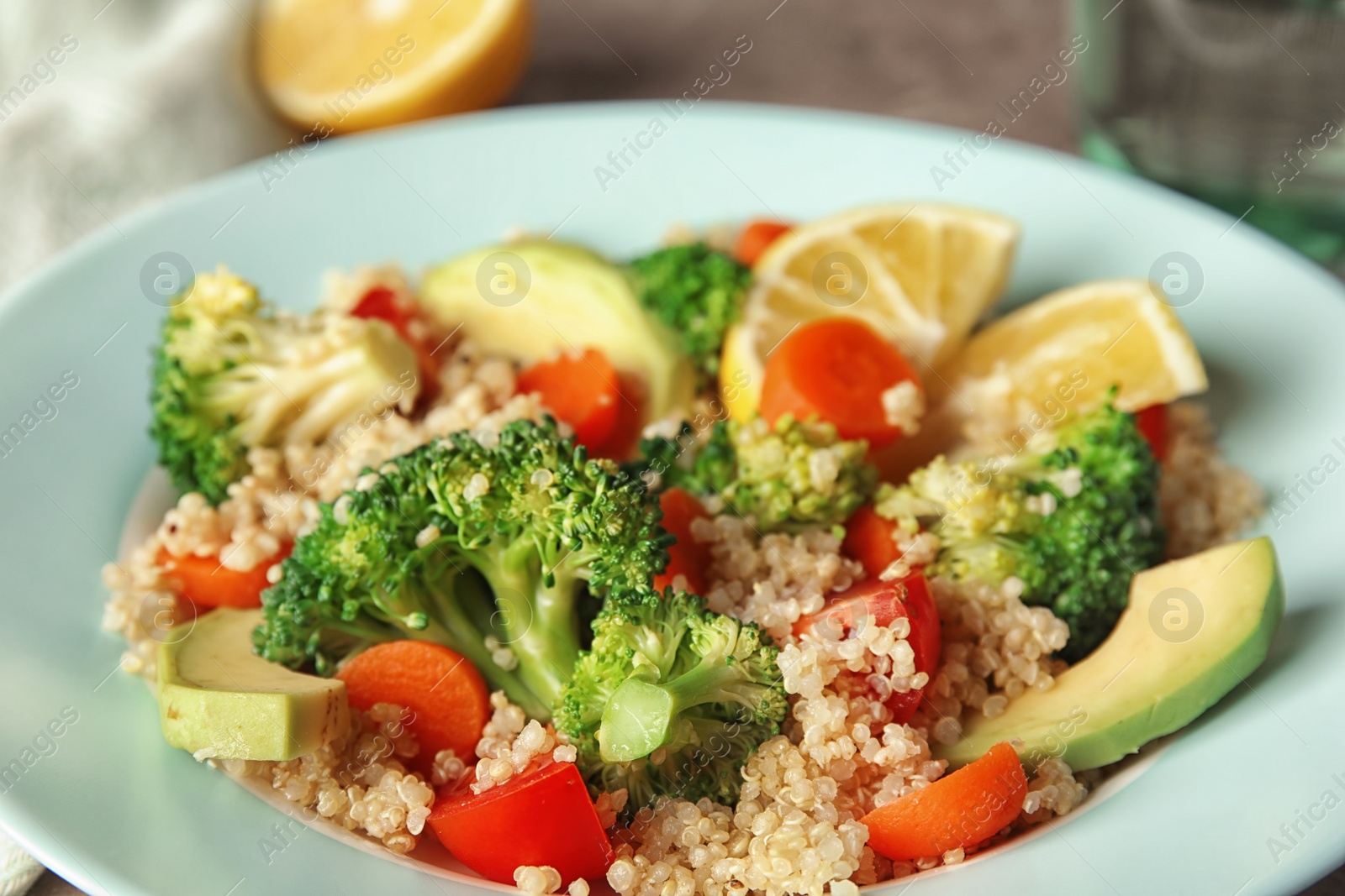 Photo of Tasty salad with quinoa in color plate, closeup