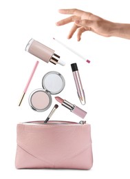 Image of Woman throwing makeup products into cosmetic bag on white background, closeup