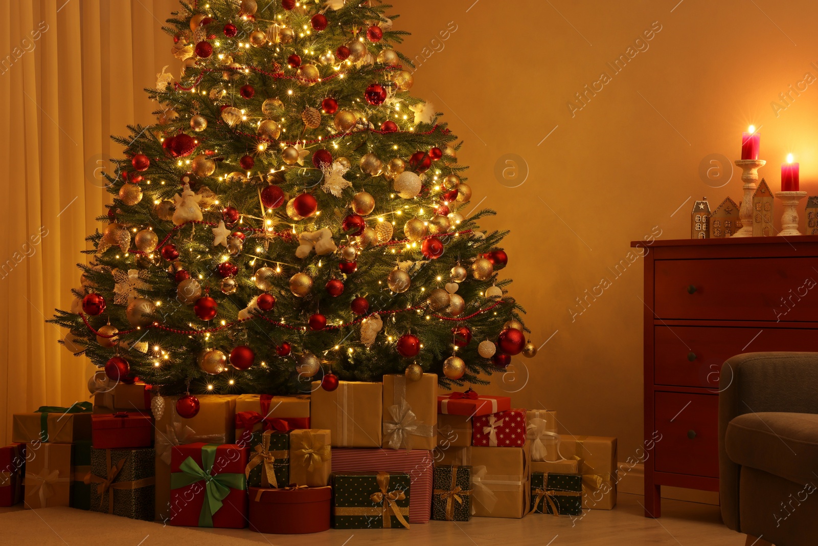 Photo of Beautiful Christmas tree and gifts indoors in evening