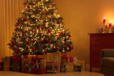 Beautiful Christmas tree and gifts indoors in evening