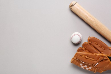 Photo of Baseball glove, bat and ball on light grey background, flat lay. Space for text