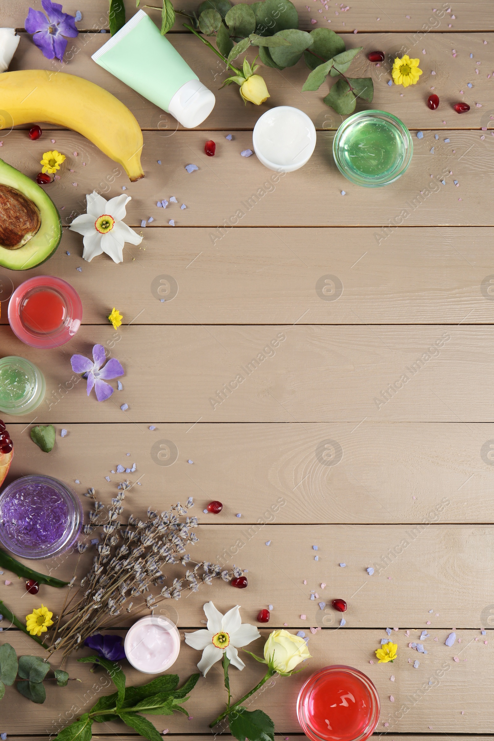 Photo of Flat lay composition with homemade cosmetic products and fresh ingredients on wooden table., space for text. DIY beauty recipe