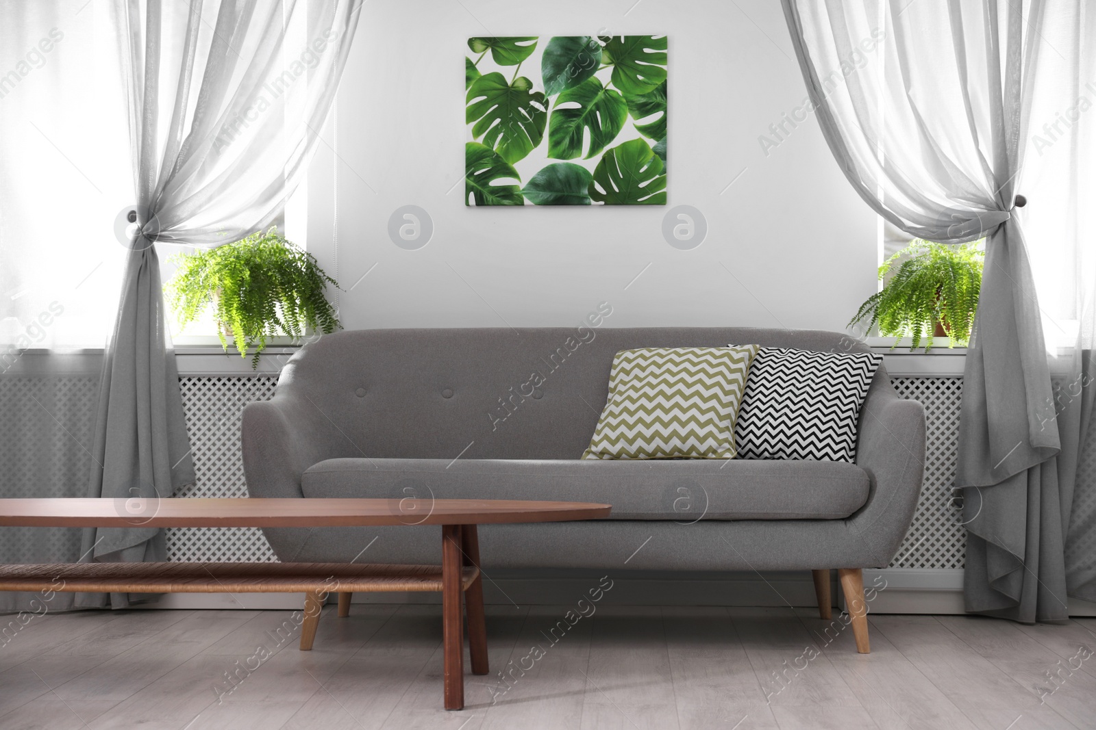 Photo of Modern comfortable sofa in stylish home interior